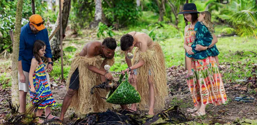 Guests learning about how the traditional Fijian lovo feast gets to be at the Jean-Michel Costeau Resort, Fiji.